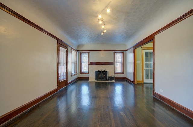 unfurnished living room featuring dark hardwood / wood-style floors and a textured ceiling