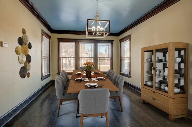 dining area featuring dark hardwood / wood-style floors, an inviting chandelier, and crown molding