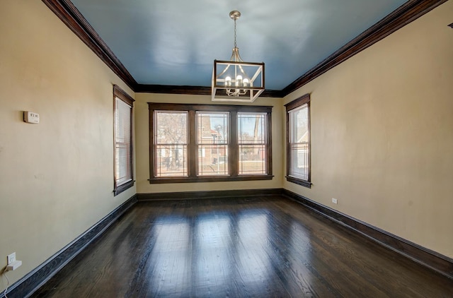 unfurnished dining area featuring ornamental molding, dark wood-type flooring, and an inviting chandelier