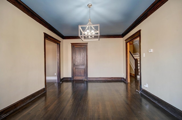 unfurnished room featuring crown molding, dark hardwood / wood-style floors, and a notable chandelier