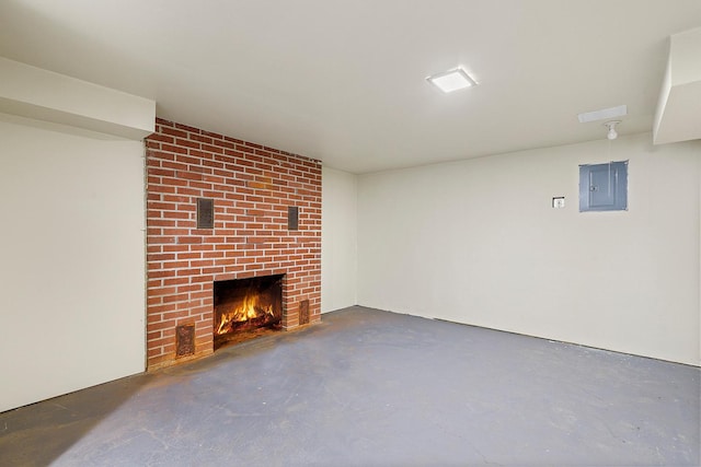 unfurnished living room featuring electric panel and a brick fireplace