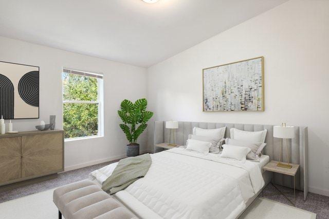 bedroom featuring light carpet and vaulted ceiling