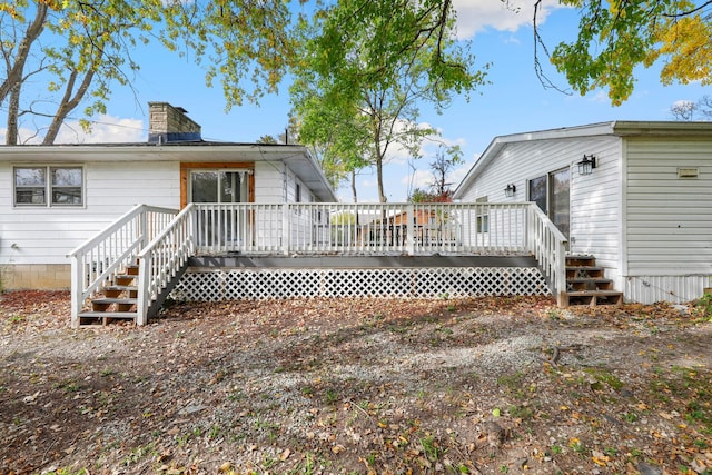 rear view of property featuring a deck