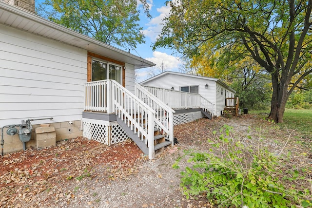 view of home's exterior with a wooden deck