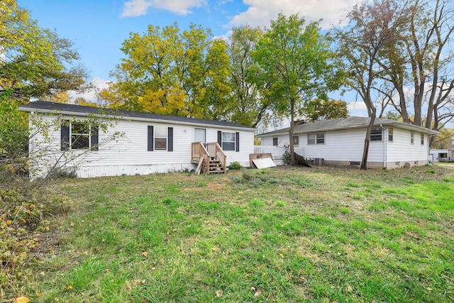 rear view of house with a yard