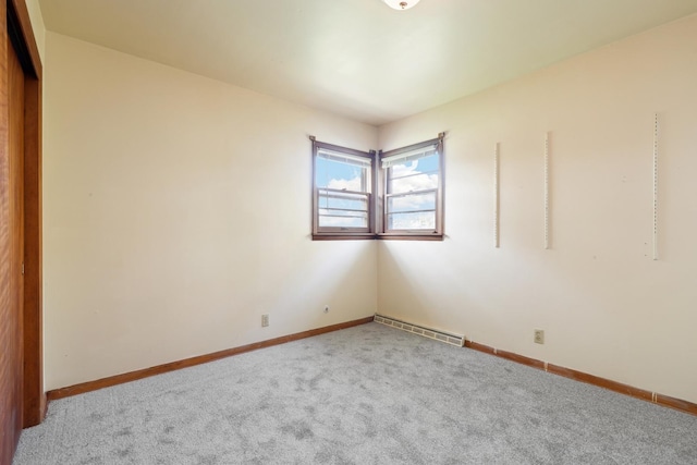 unfurnished room featuring carpet flooring and baseboard heating