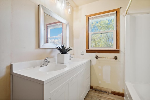 bathroom with vanity and hardwood / wood-style flooring