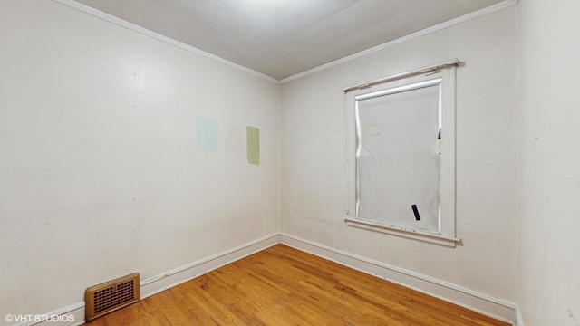 unfurnished room with hardwood / wood-style floors and ornamental molding