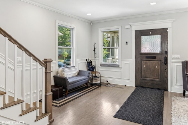 foyer featuring hardwood / wood-style floors and ornamental molding