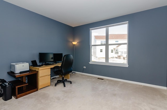 carpeted home office featuring visible vents and baseboards