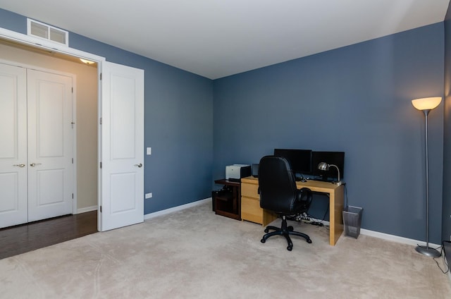 carpeted home office with visible vents and baseboards