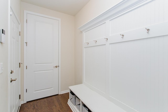 mudroom with dark wood-style floors and baseboards