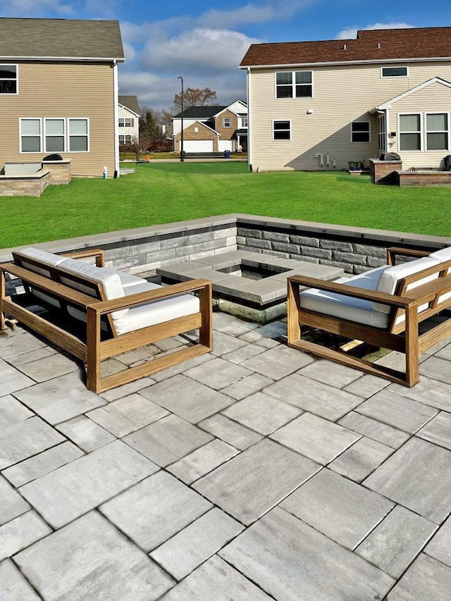 view of patio / terrace featuring a residential view and an outdoor living space with a fire pit