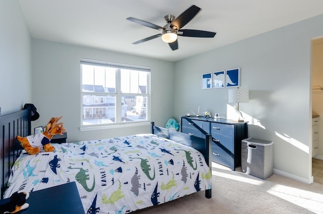 bedroom featuring baseboards, carpet floors, and a ceiling fan