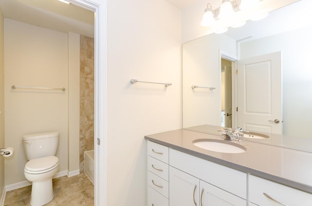 bathroom with baseboards, toilet, vanity, and tile patterned flooring