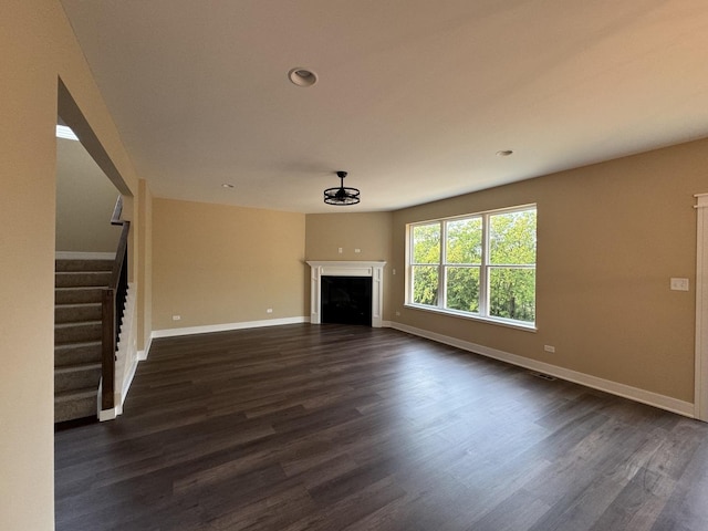 unfurnished living room featuring dark hardwood / wood-style floors