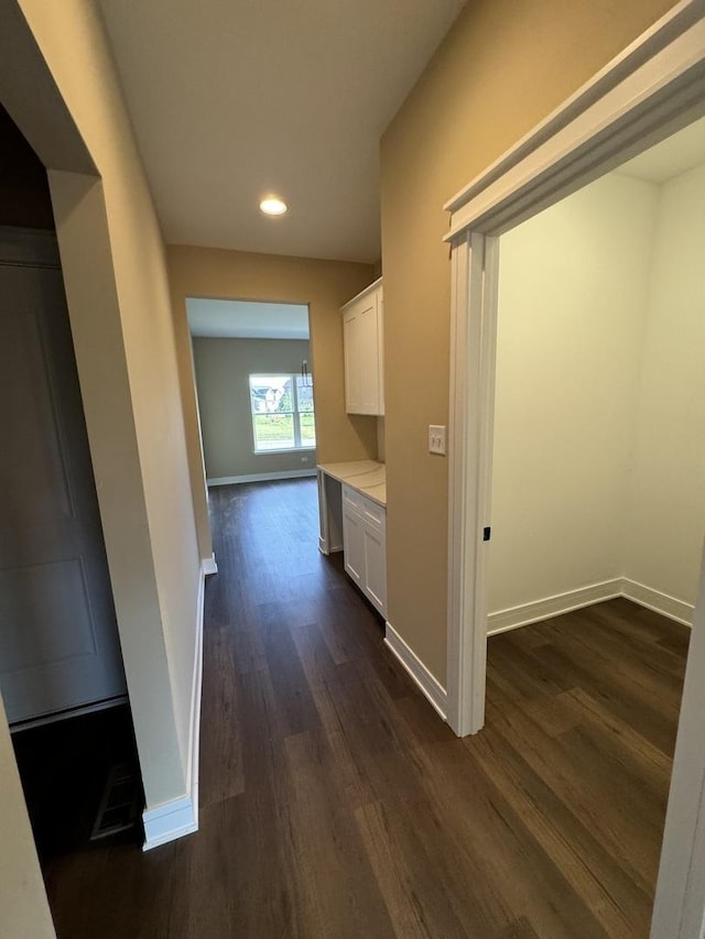 hallway with dark wood-type flooring