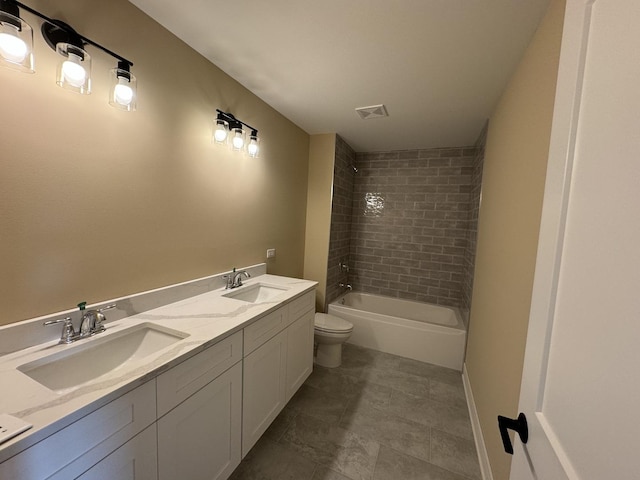 full bathroom with vanity, toilet, and tiled shower / bath combo