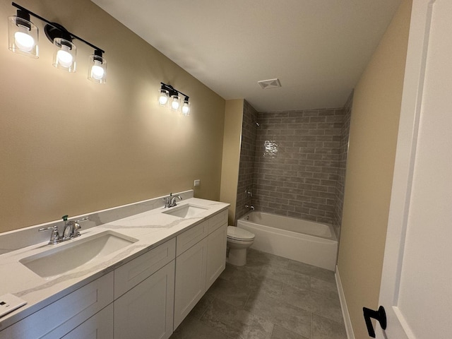 full bathroom featuring vanity, toilet, and tiled shower / bath combo