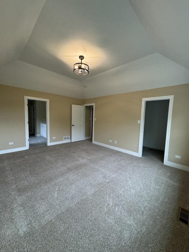 unfurnished bedroom with lofted ceiling and carpet floors