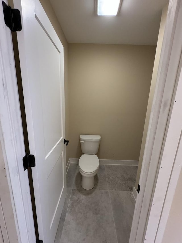 bathroom featuring tile patterned floors and toilet