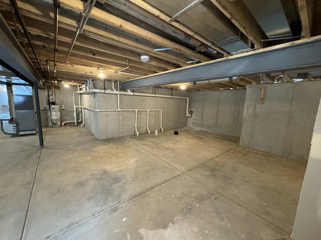 basement featuring gas water heater and heating unit