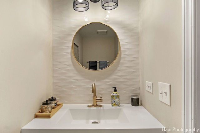 bathroom featuring sink and tasteful backsplash