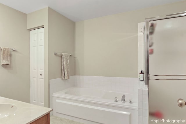 bathroom with plus walk in shower and vanity