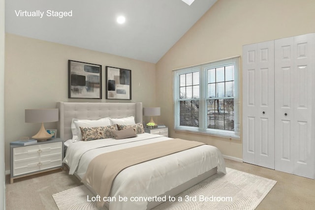 bedroom with light colored carpet and high vaulted ceiling