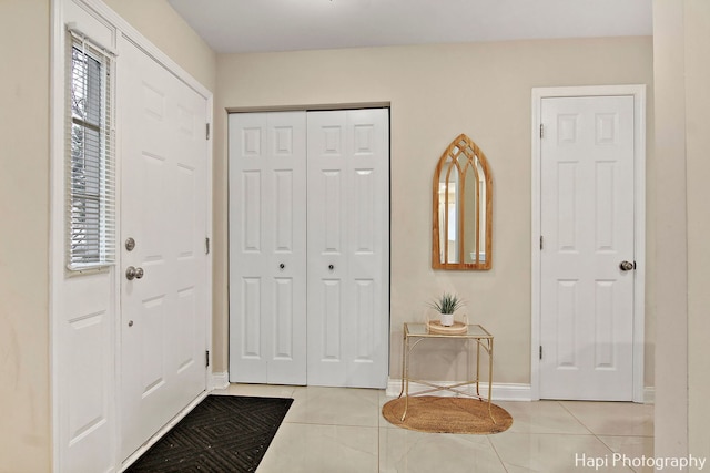 tiled foyer featuring a healthy amount of sunlight