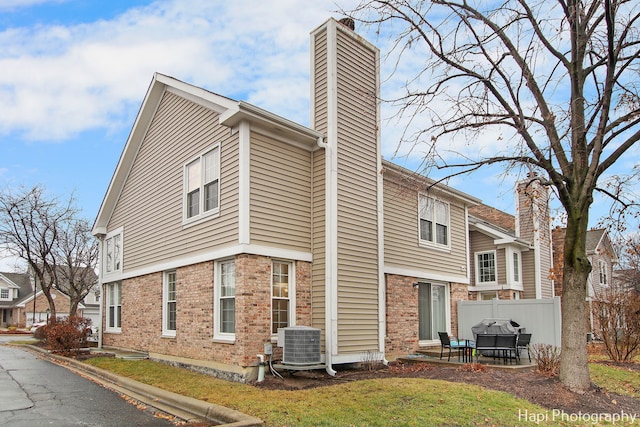 view of side of home featuring central air condition unit