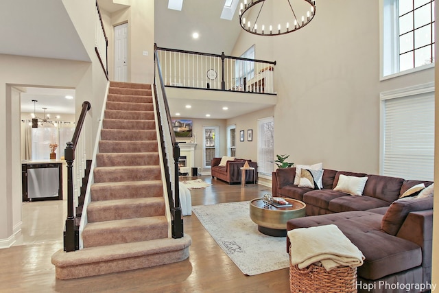 living room with plenty of natural light, a chandelier, and a high ceiling