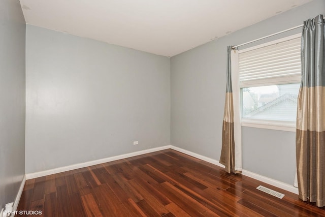 spare room featuring dark wood-type flooring