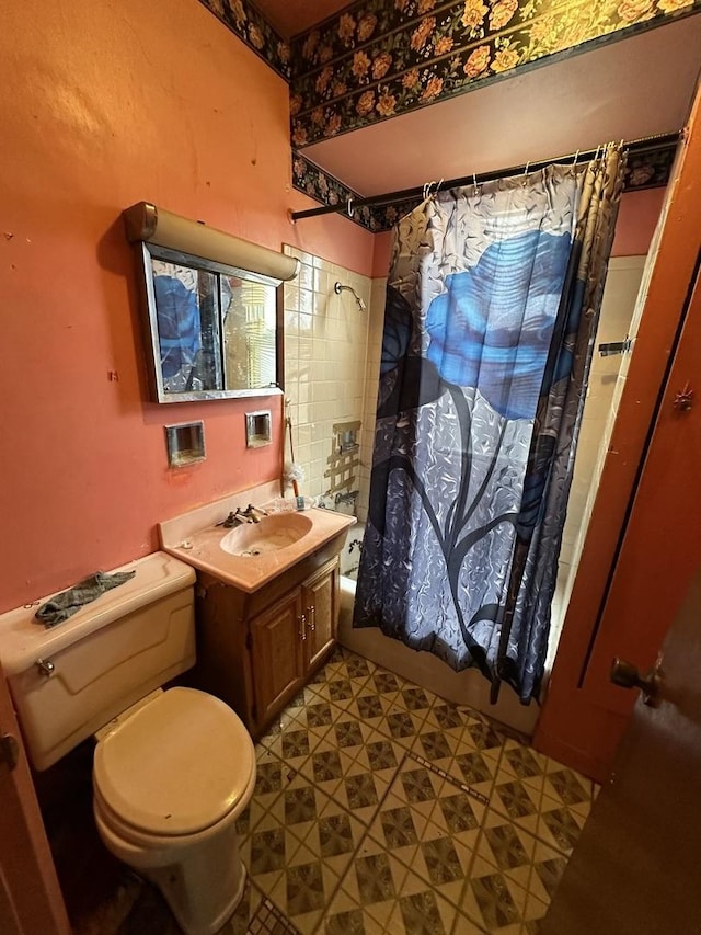 full bathroom with vanity, shower / bath combo, and toilet