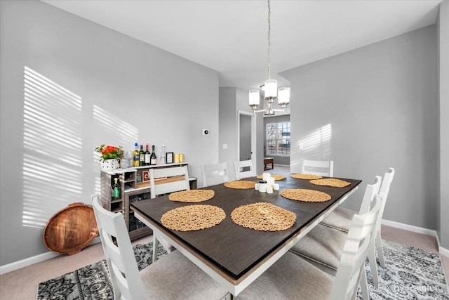 carpeted dining area featuring a chandelier