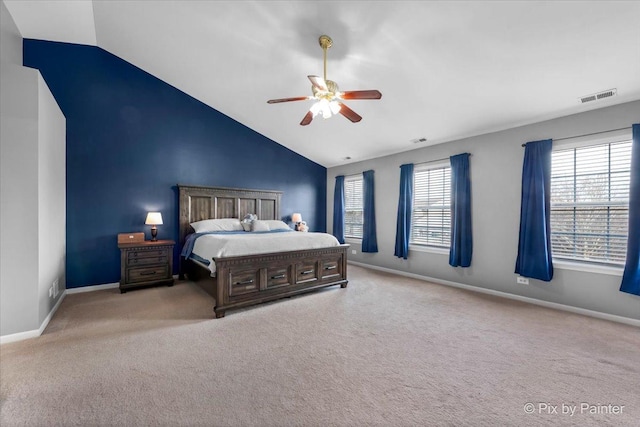 bedroom featuring ceiling fan, vaulted ceiling, and light carpet