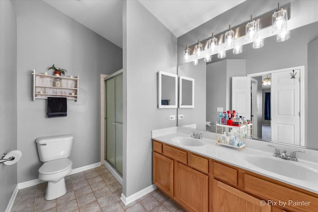 bathroom featuring vanity, a shower with shower door, and toilet