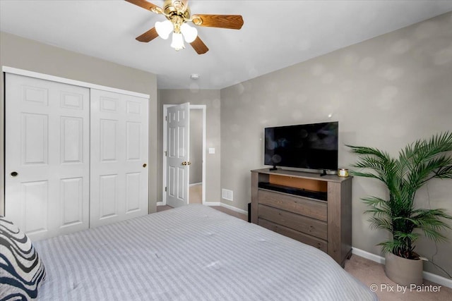 bedroom with ceiling fan, a closet, and carpet floors