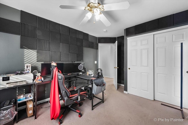 carpeted office featuring ceiling fan