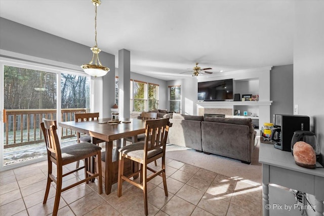 dining area featuring ceiling fan and light tile patterned flooring