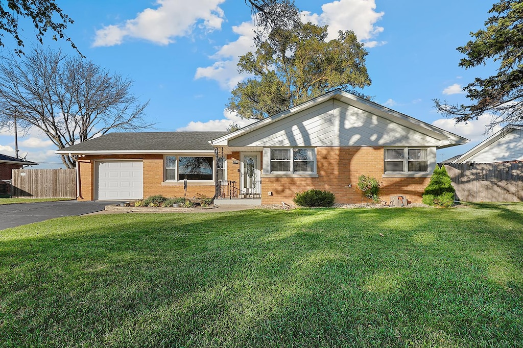 single story home with a garage and a front yard