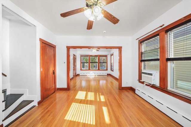 corridor with cooling unit, a baseboard radiator, and light hardwood / wood-style floors