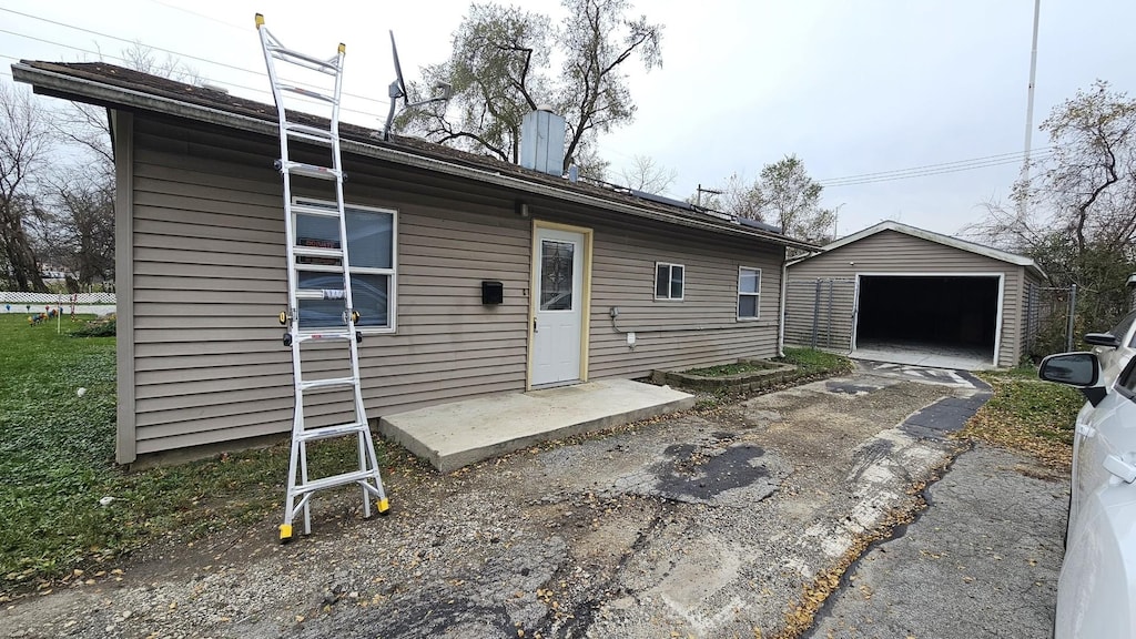 view of front of home featuring a garage and an outdoor structure