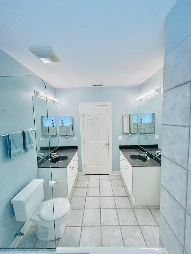 bathroom with tile patterned flooring, vanity, and toilet