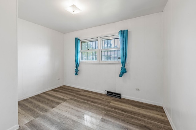 unfurnished room with hardwood / wood-style floors