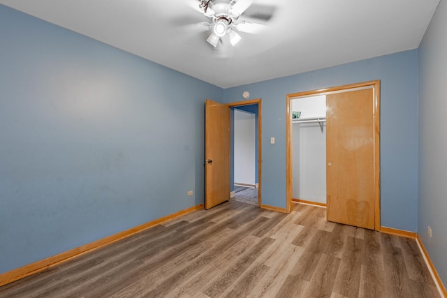 unfurnished bedroom with hardwood / wood-style floors, a closet, and ceiling fan