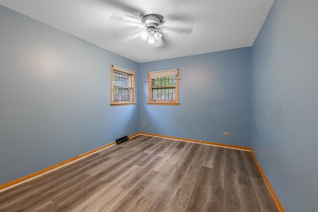 spare room featuring hardwood / wood-style floors and ceiling fan