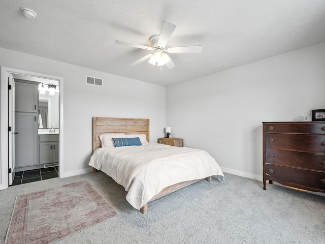 carpeted bedroom featuring ensuite bathroom and ceiling fan