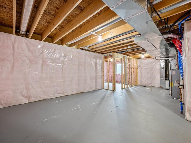 basement featuring heating unit and water heater