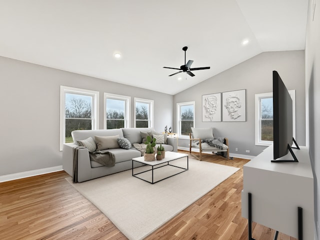 living room featuring hardwood / wood-style flooring, vaulted ceiling, and ceiling fan